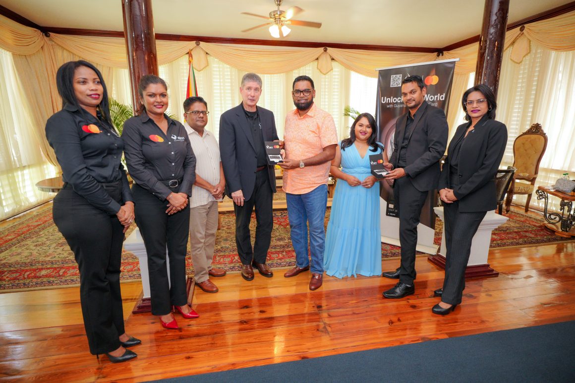 His Excellency President Irfaan Ali and First Lady Arya Ali receiving Guyana's first Black Card from GBTI CEO James Foster, Deputy CEO Shawn Gurcharran. Also in photo from L-R are Vanessa Cordis, Dahana Ramjist, Minister of Finance, Dr Ashni Singh and Rawattie Mohandeo, Business Development Manager