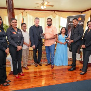 His Excellency President Irfaan Ali and First Lady Arya Ali receiving Guyana's first Black Card from GBTI CEO James Foster, Deputy CEO Shawn Gurcharran. Also in photo from L-R are Vanessa Cordis, Dahana Ramjist, Minister of Finance, Dr Ashni Singh and Rawattie Mohandeo, Business Development Manager