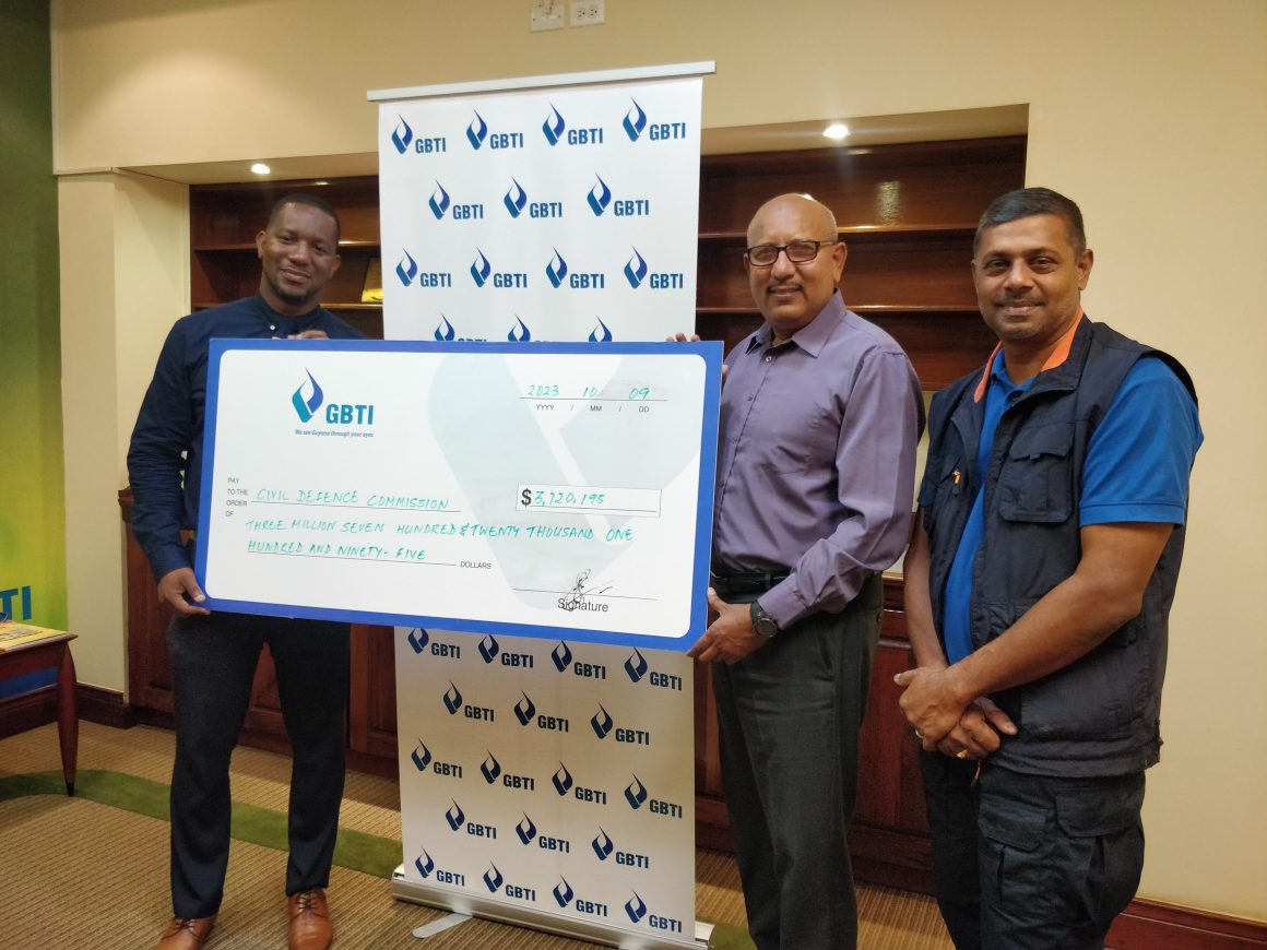 GBTI's Marketing Manager Pernell Cummings presenting the cheque to CDC Director General Colonel (Retired) Nazrul Hussain at GBTI Corporate Office, Kingston, Georgetown. Also in photo is Major Richard Persaud