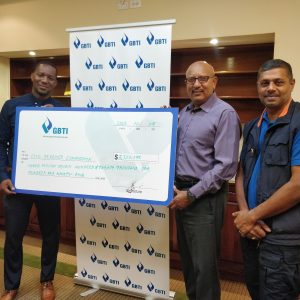 GBTI's Marketing Manager Pernell Cummings presenting the cheque to CDC Director General Colonel (Retired) Nazrul Hussain at GBTI Corporate Office, Kingston, Georgetown. Also in photo is Major Richard Persaud